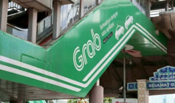 A grab advertisment is shown on the wall of a staircase