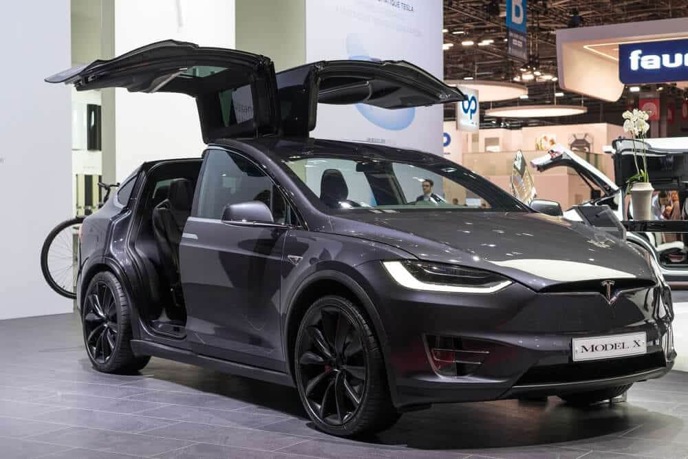 Black Tesla Model X inside a convention with its doors opened - the car that made Tesla Stock crash