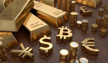 Gold bars and coins with gold currency symbols