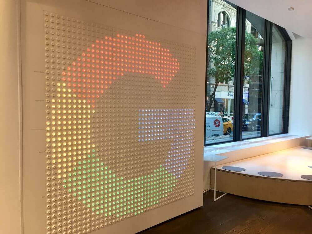 google, the letter G from the google logo is painted on a white wall