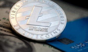 litecoin coin with a card and a dollar bill on the background