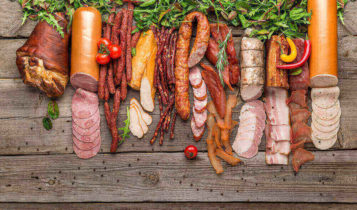 Various pork products neatly placed on a wood background based on new tariffs