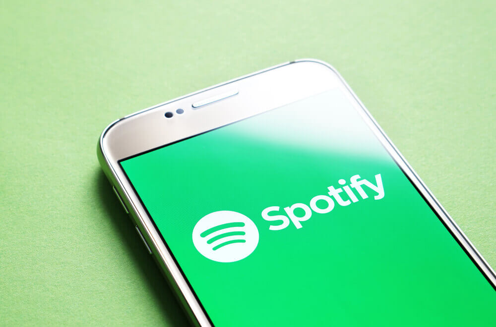 Spotify logo shown on a phone with green background