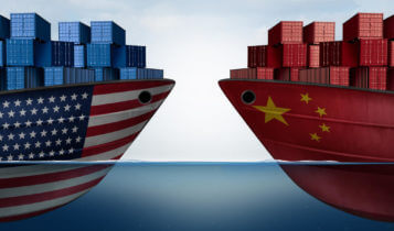 Illustrated form of trade war as a US cargo ship is facing a china cargo ship