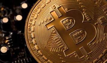 bitcoin logo is engraved on a coin