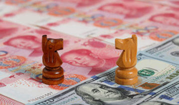 2 chess pieces facing each other on dollar bills and yuan bills
