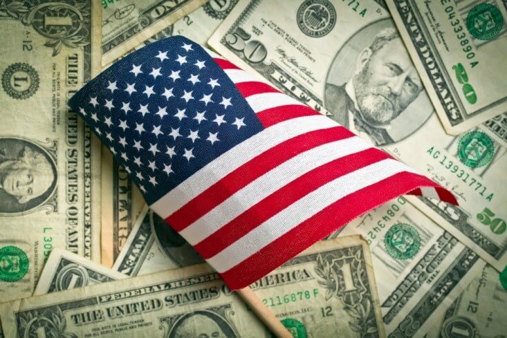 Currency Pairs- Miniature US flag on top of dollar bills - Finance Brokerage 