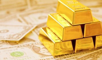 Finance Brokerage-Futures Trading: Gold bars stacked on top of each other on dollar bills