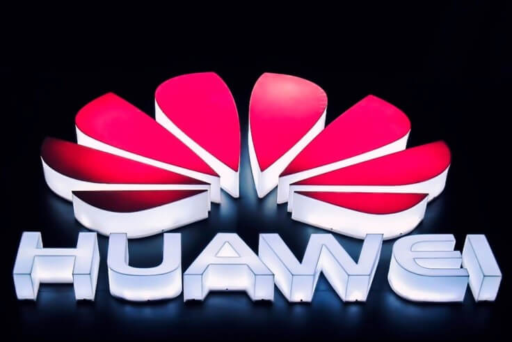 Finance Brokerage-Huawei: undershot of lit up Huawei logo on dark background
