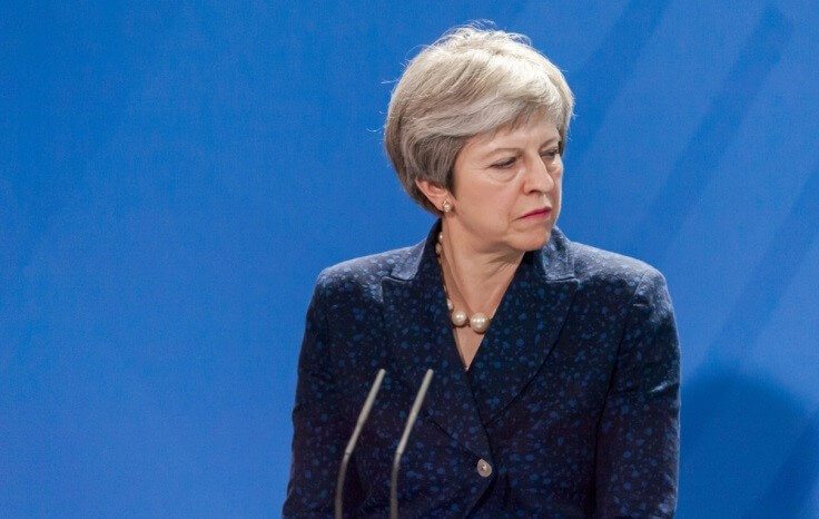 UK Prime Minister – Theresa May looking at her left during a speech – Finance Brokerage 