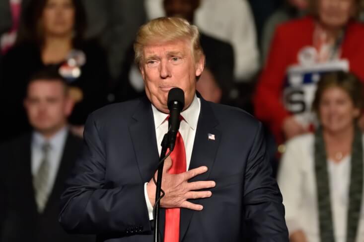 trump, Finance Brokerage – Forex News: Trump holding his chest during a speech