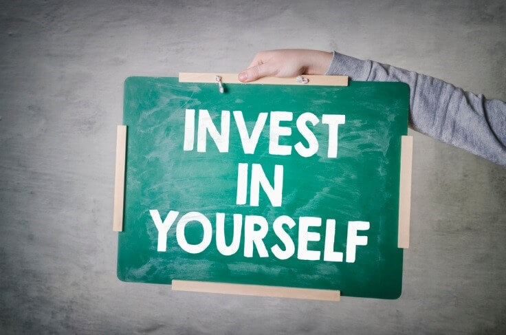 invest in yourself written in a chalkboard – FinanceBrokerage