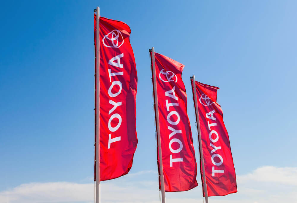 Toyota: Official dealership flags of Toyota against the blue sky background.