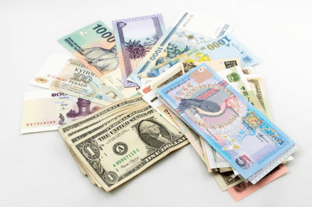 The picture demonstrates the different currencies in the world with a white background behind it