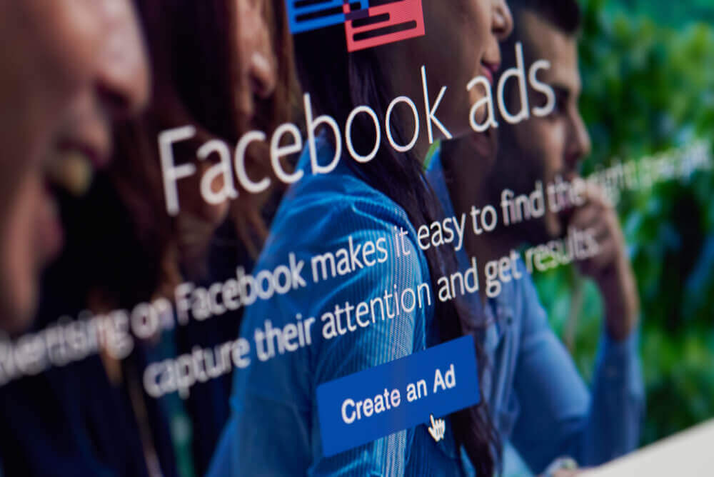 Create an Ad on facebook app on screen close-up.