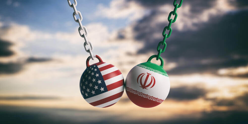 oil prices: USA and Iranian flags wrecking balls swinging on blue cloudy sky background.