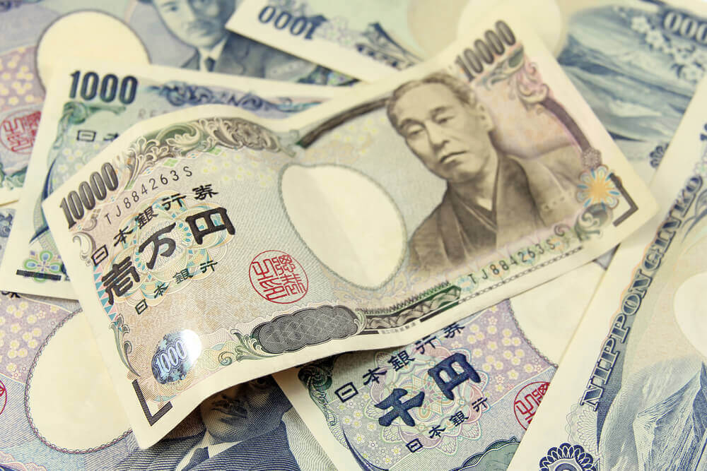 Selective focus on heap of Japanese yen banknotes.