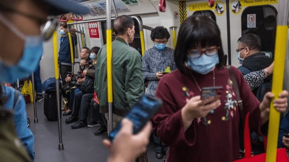 People wearing protective masks on a train in Hong Kong