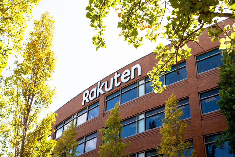 A logo sign of Rakuten outside of the headquarters.