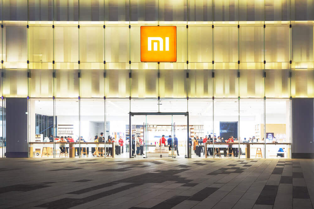Customers experience xiaomi products in the xiaomi store at night.