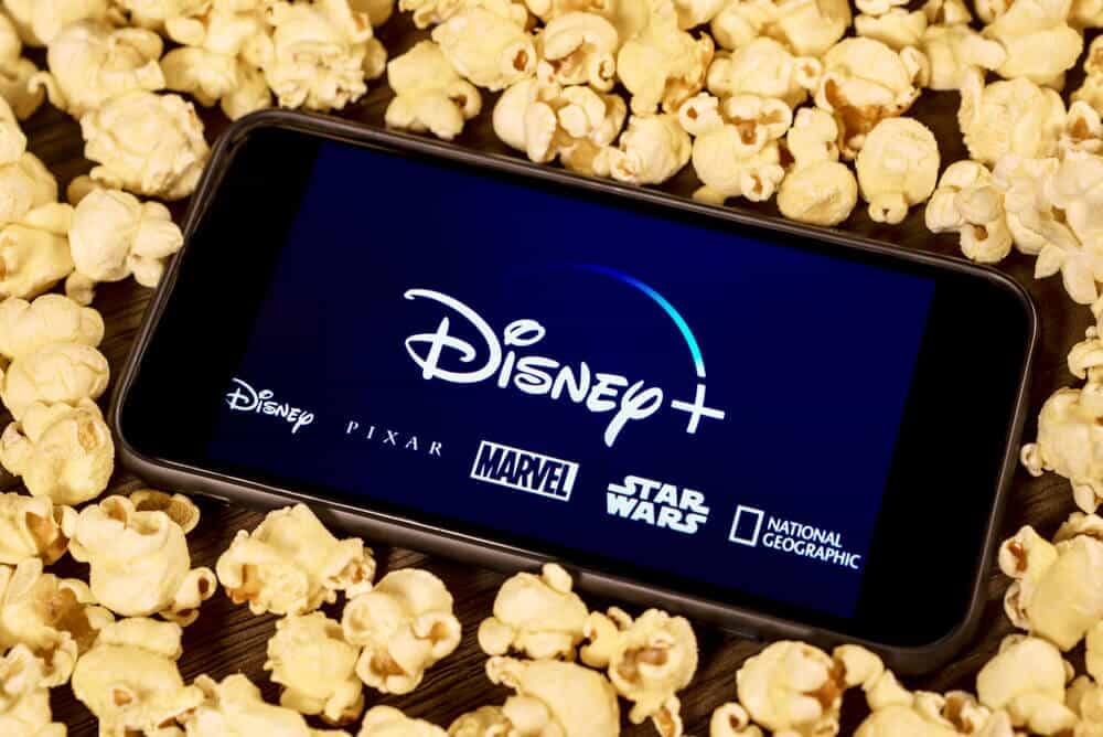 Disney Plus on smartphone with popcorn.