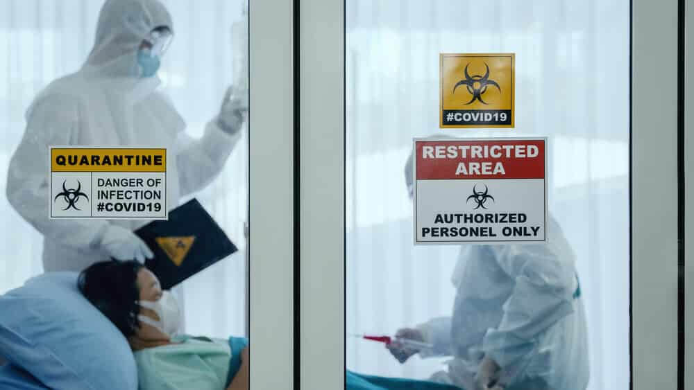 coronavirus covid 19 quarantine and breakout alert sign on window of quarantine room.