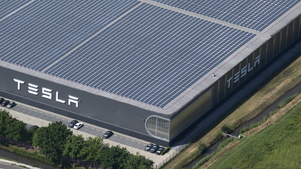 Aerial view of Tesla Motors assembly car factory. The roof is full with solar panels.