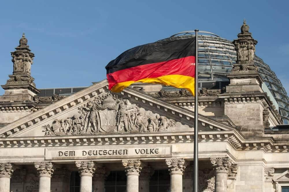 Flag of the Federal Republic of Germany is waving in front of the national german parliament.