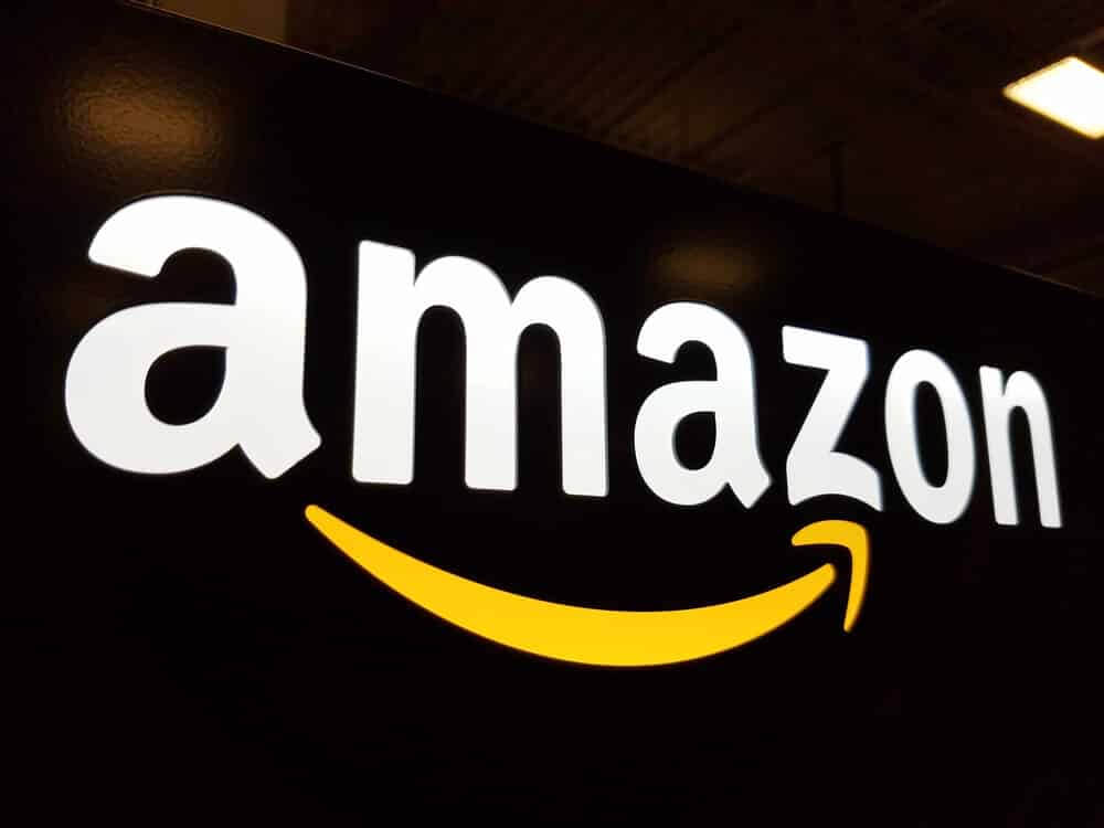 Amazon logo on black shiny wall.