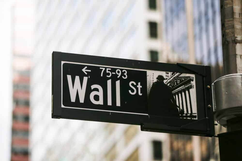 A street sign shows the world's financial center wall street.