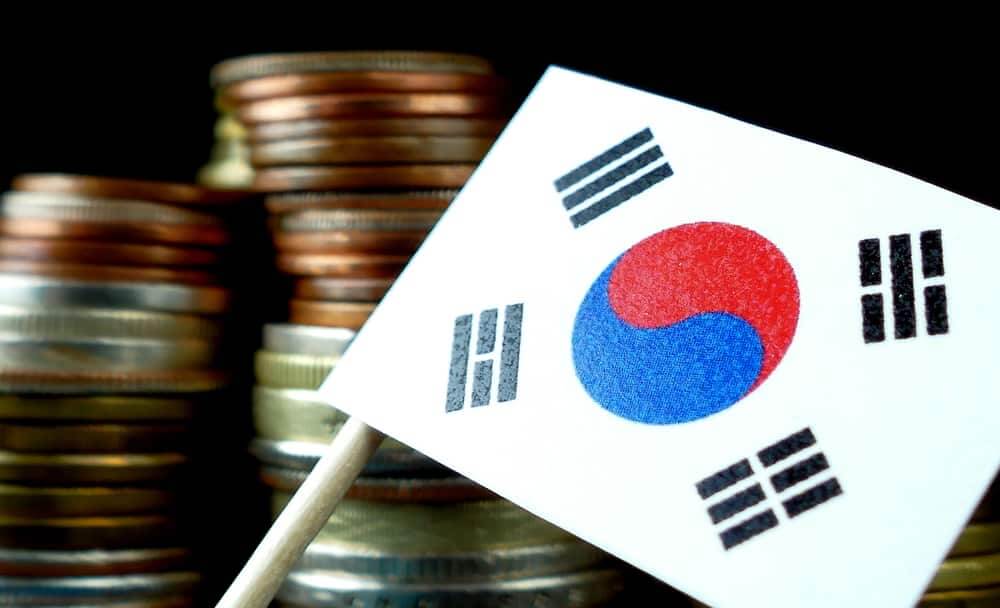 bandeira da coreia e moedas no fundo